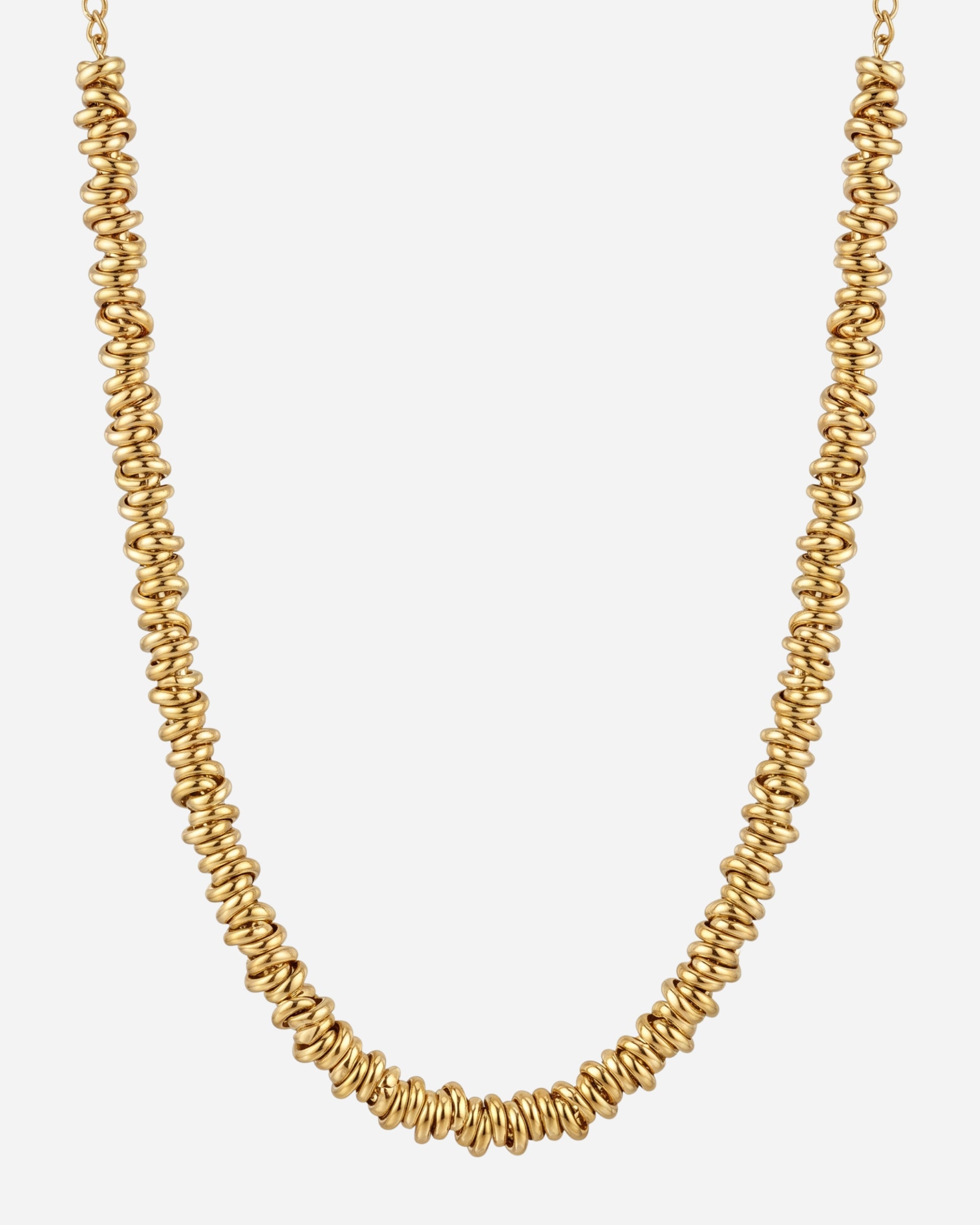 Gold necklace with spiral-shaped beads on a plain background