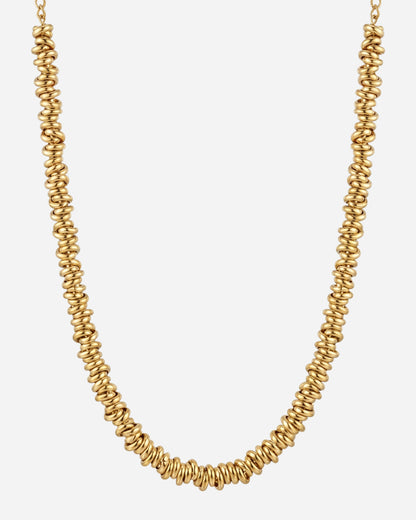 Gold necklace with spiral-shaped beads on a plain background
