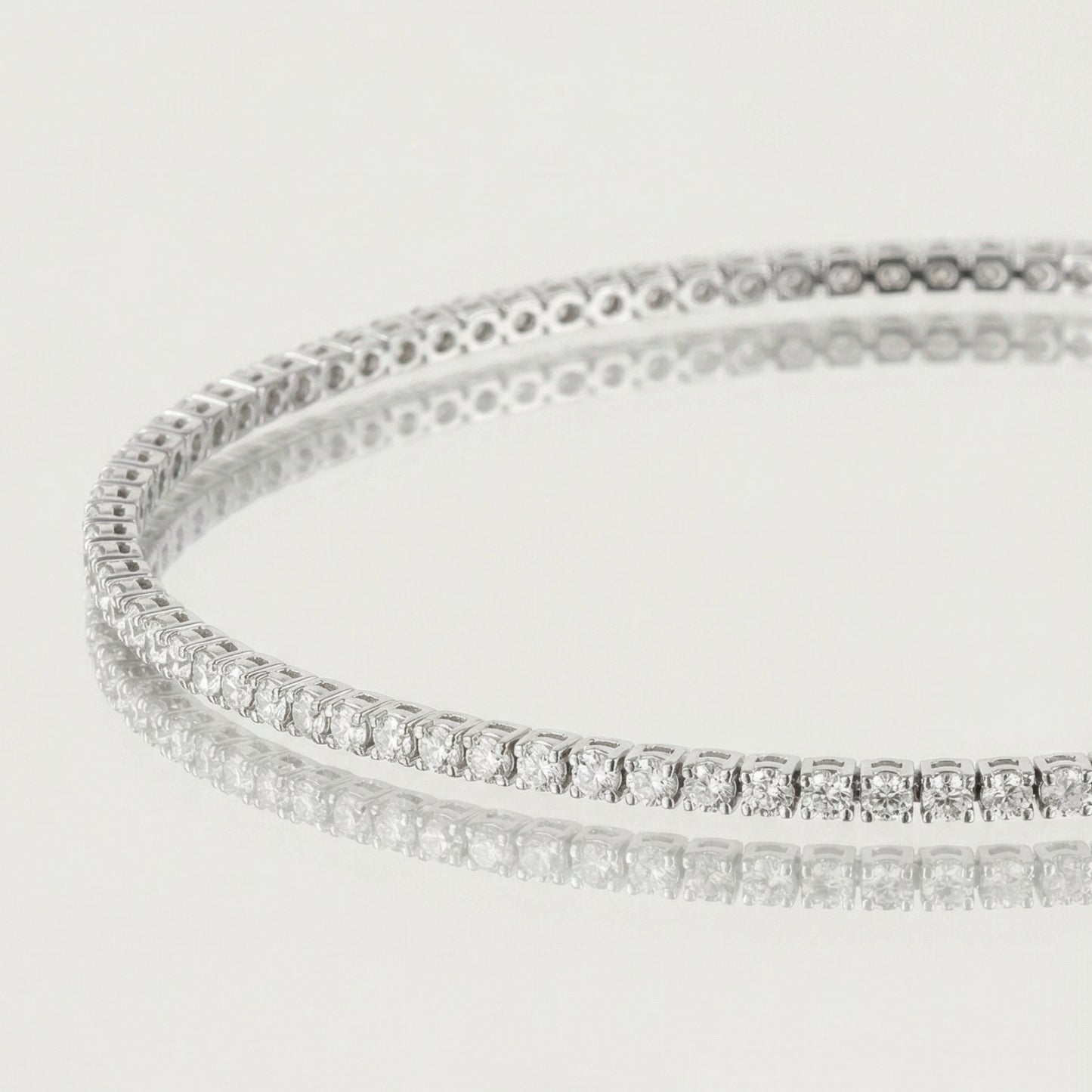 Silver bracelet with clear stones on a light gray background
