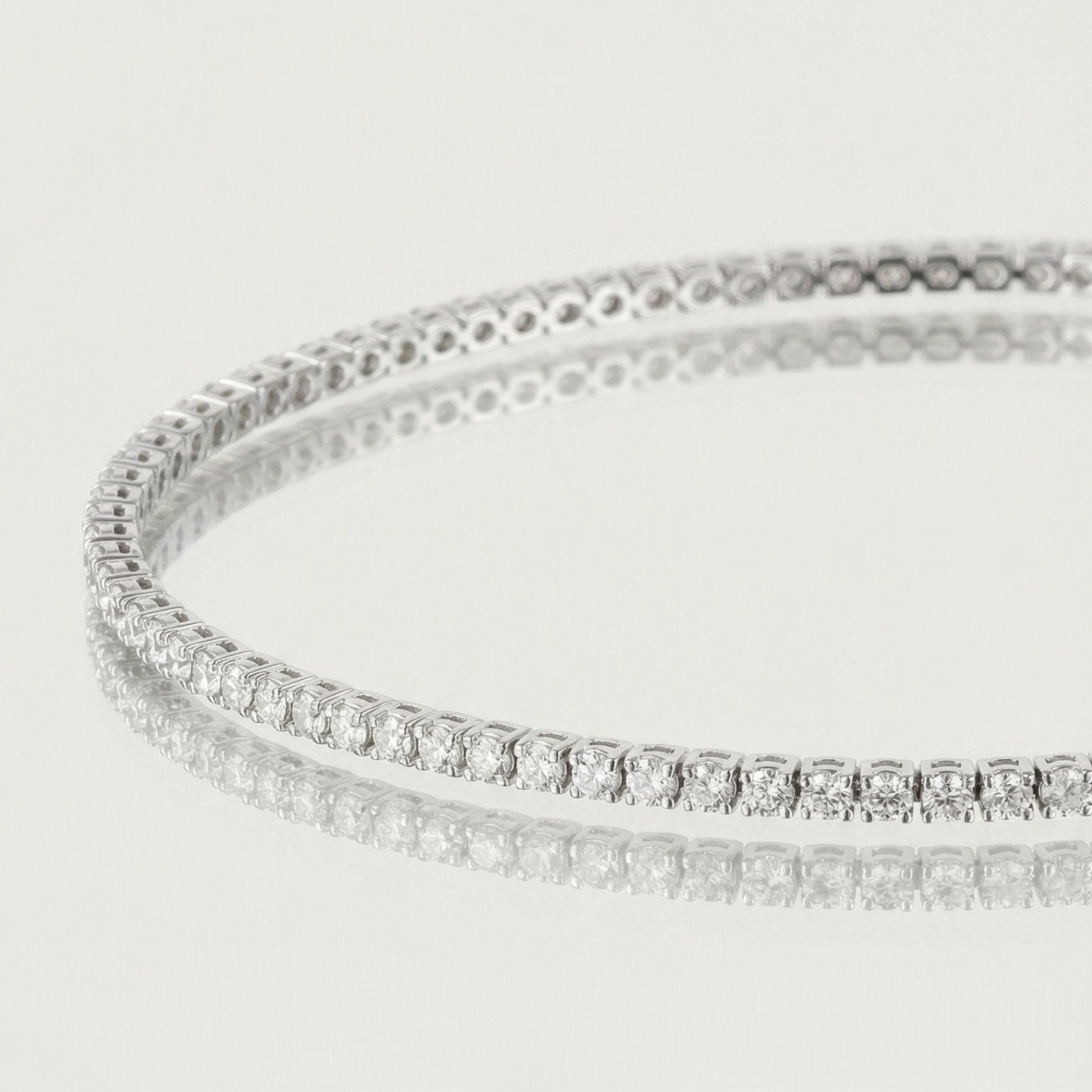 Silver bracelet with clear stones on a light gray background