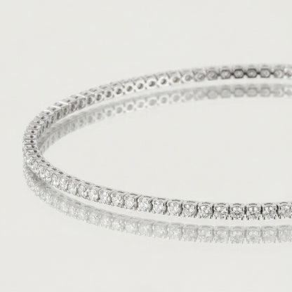 Silver bracelet with clear stones on a light gray background