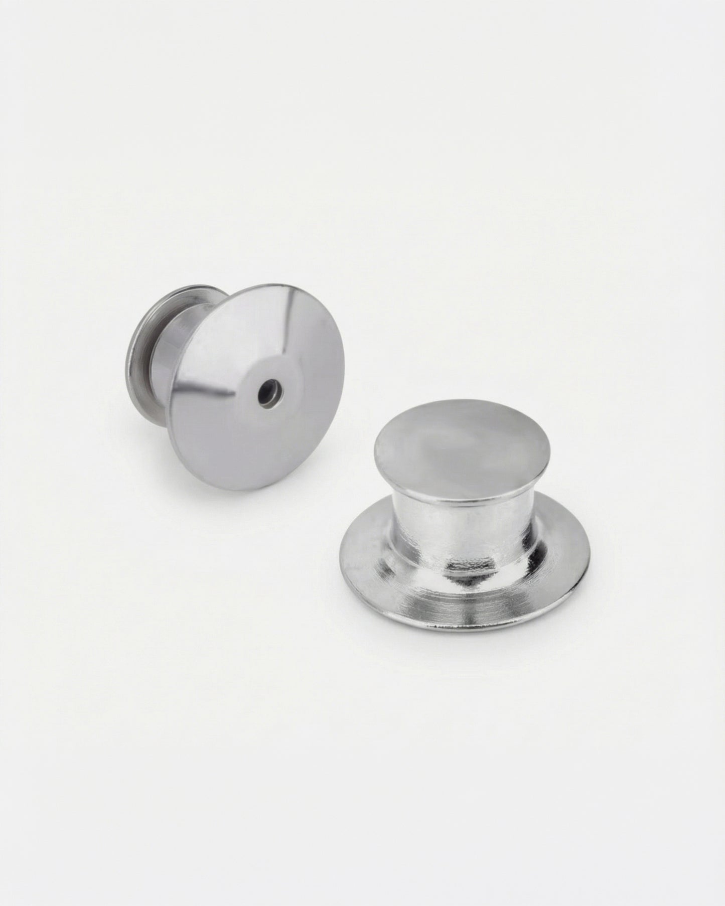 Two metallic buttons on a plain white background.