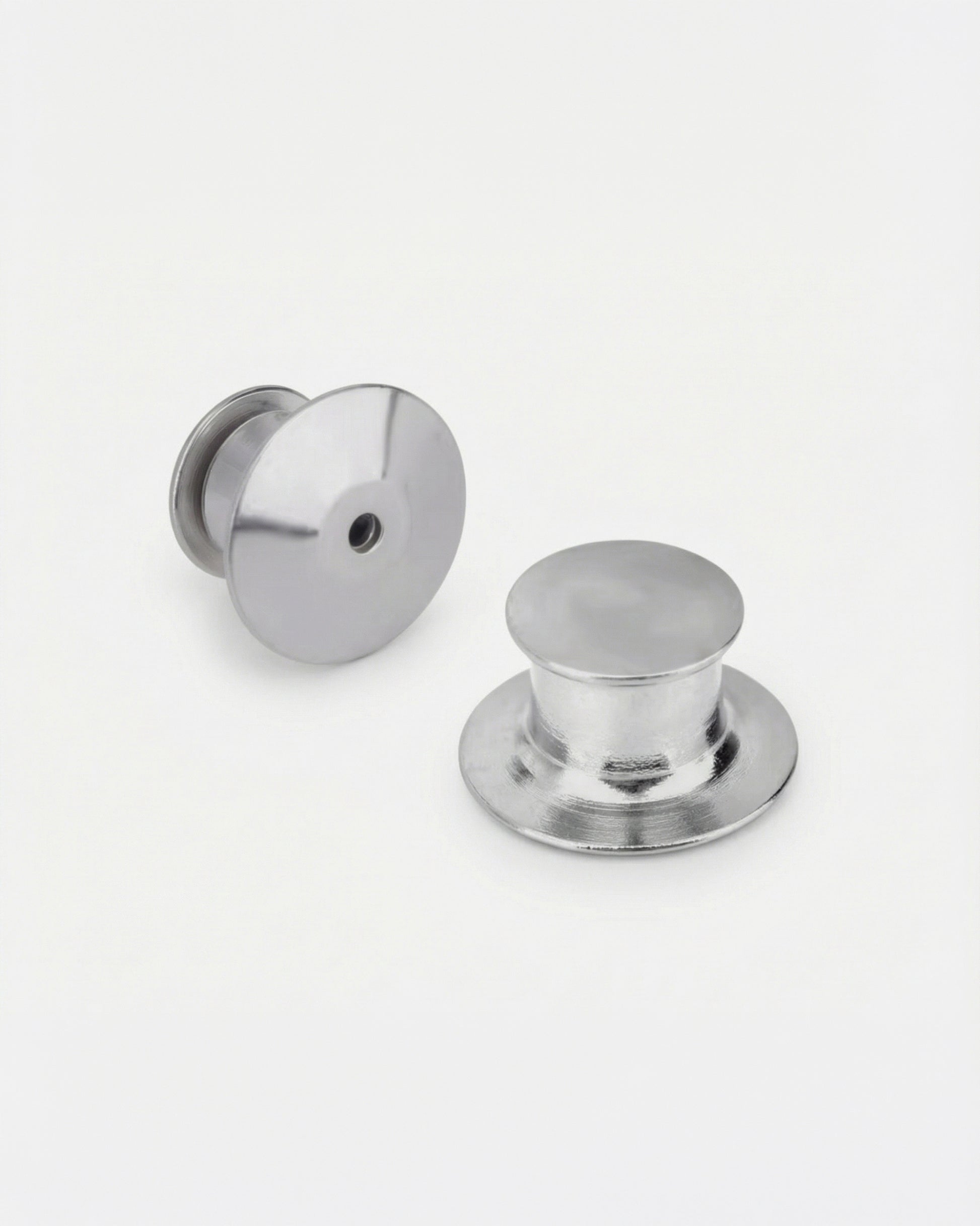 Two metallic buttons on a plain white background.