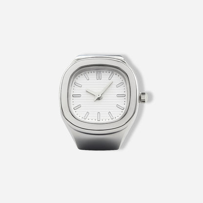 Silver ring watch with a white face on a light gray background