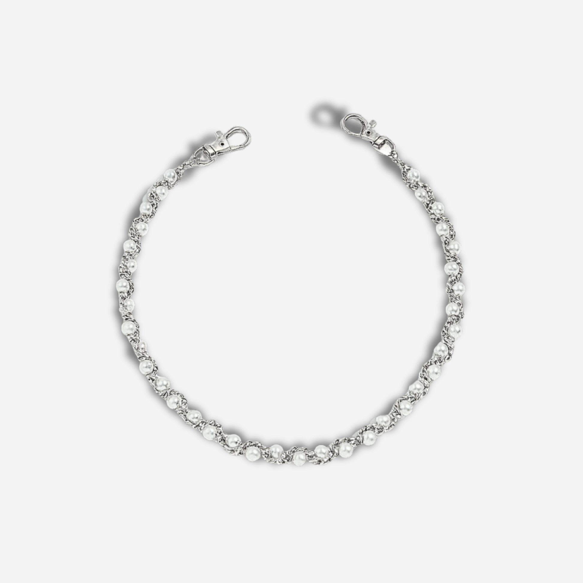 Silver bracelet with clear stones on a light gray background
