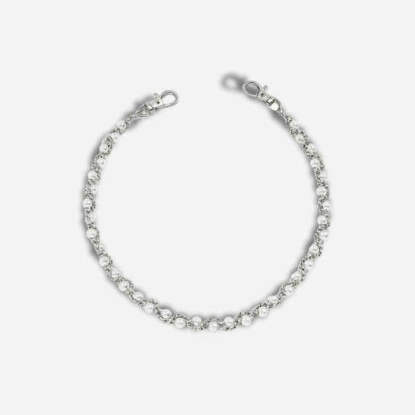 Silver bracelet with clear stones on a light gray background