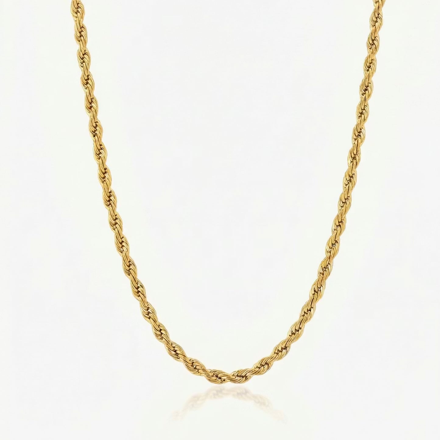 Gold rope chain necklace on a white background
