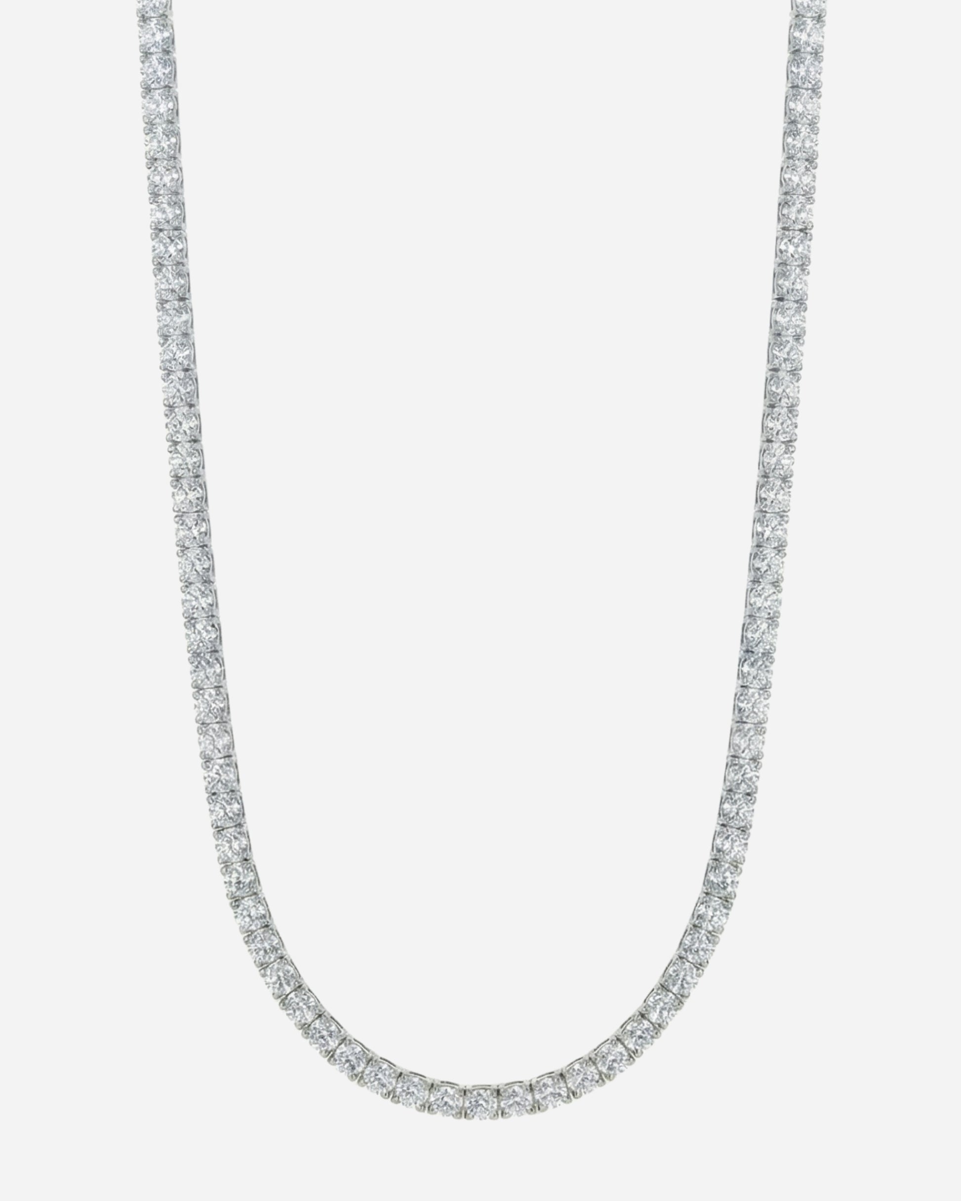Silver necklace with a row of clear stones on a plain background.