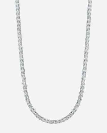 Silver necklace with a row of clear stones on a plain background.