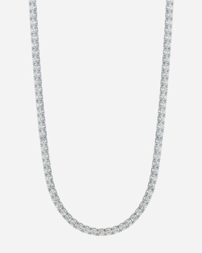 Silver necklace with a row of clear stones on a plain background.