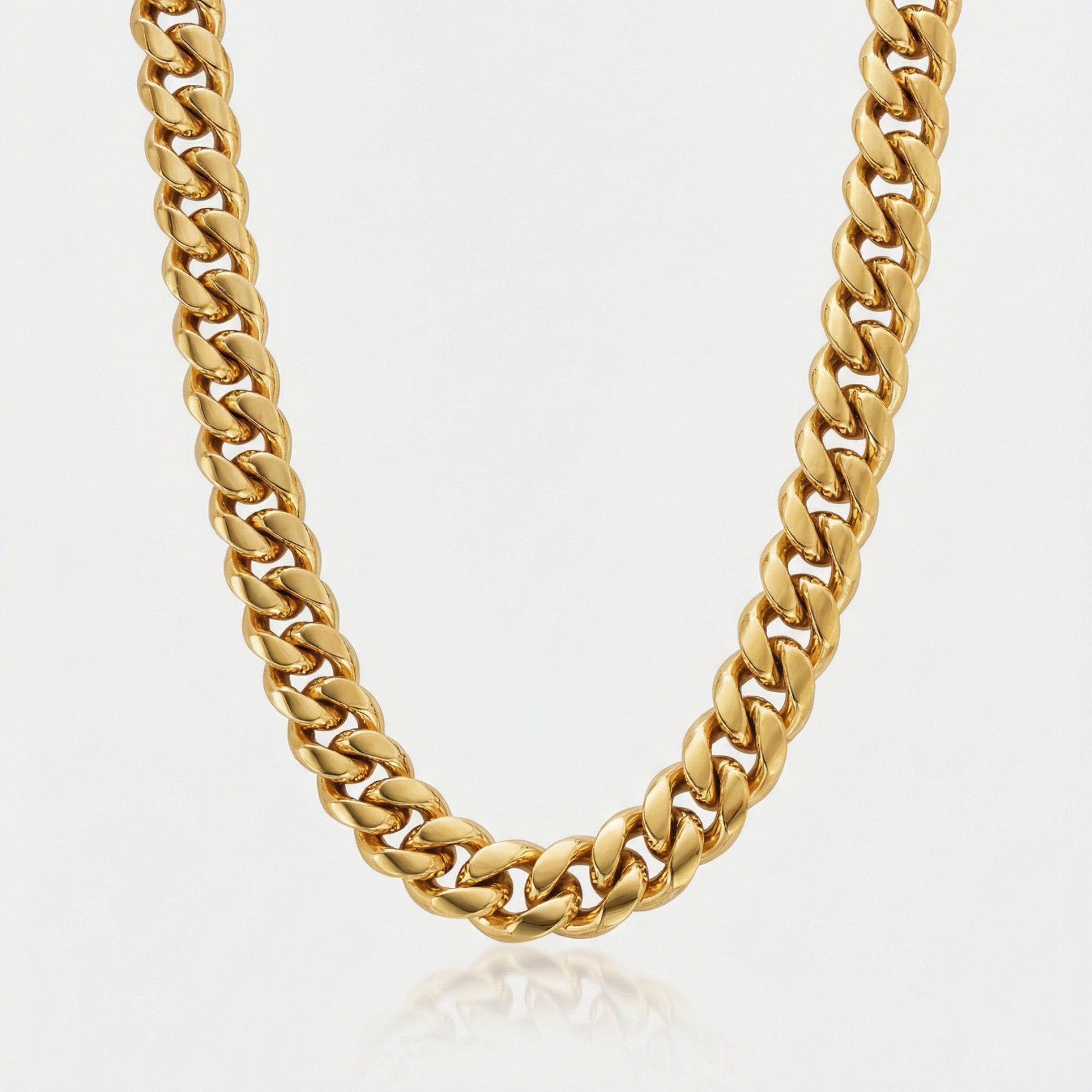Gold chain necklace on a light gray background