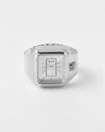 Silver rectangular watch with a white face and Roman numerals on a plain background.