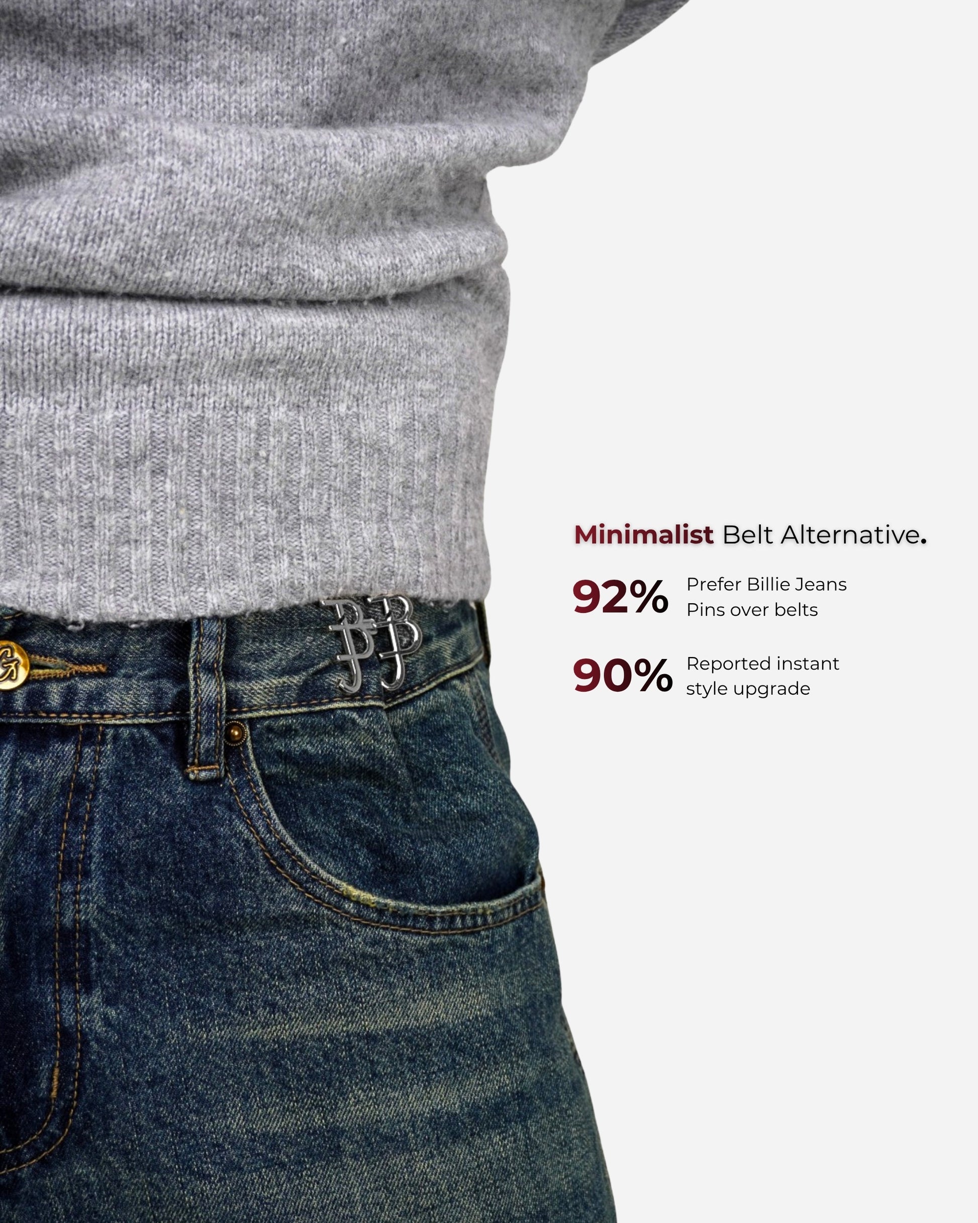 Close-up of a gray sweater and denim jeans with pins at the waist.