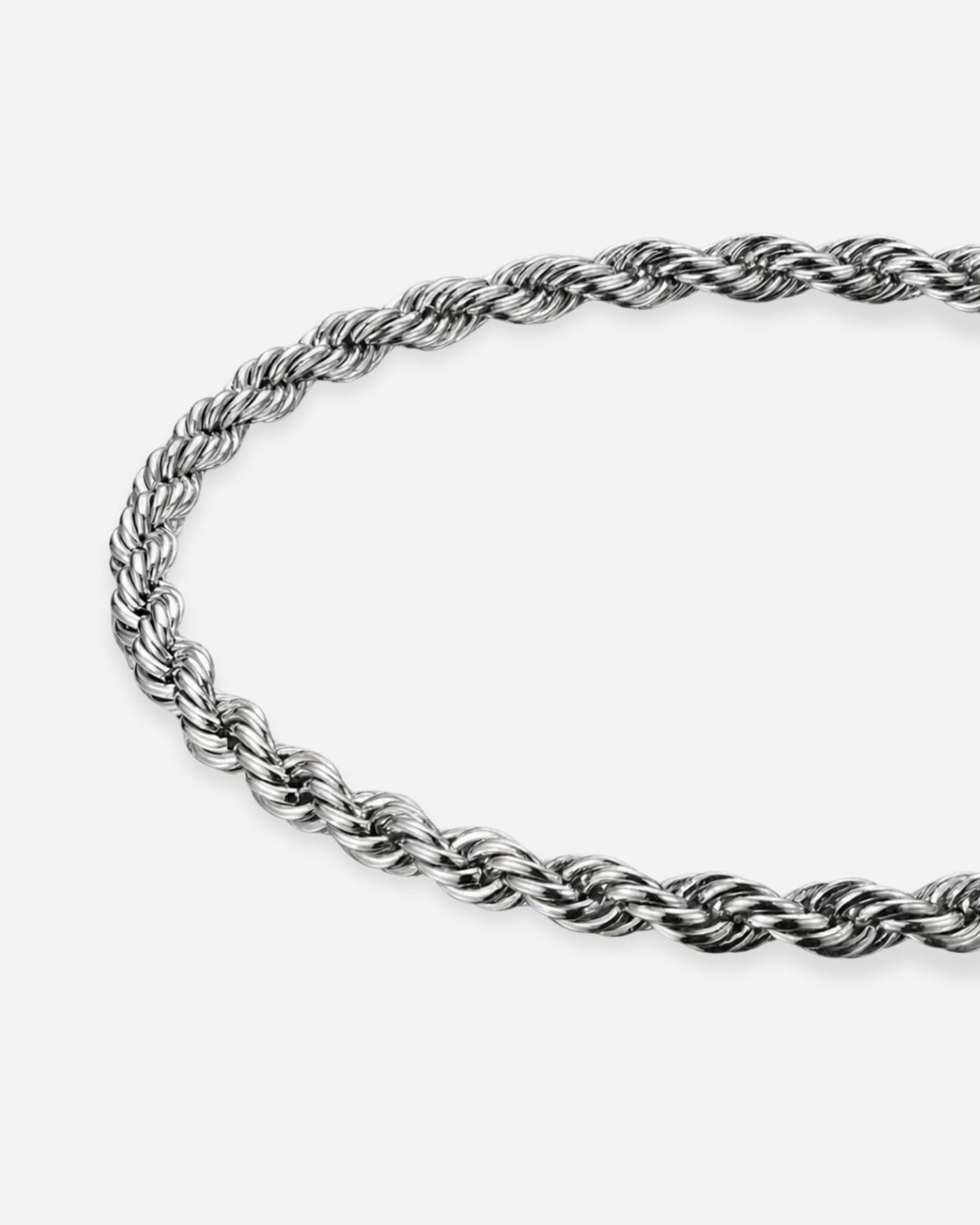 Twisted silver chain necklace on a plain background