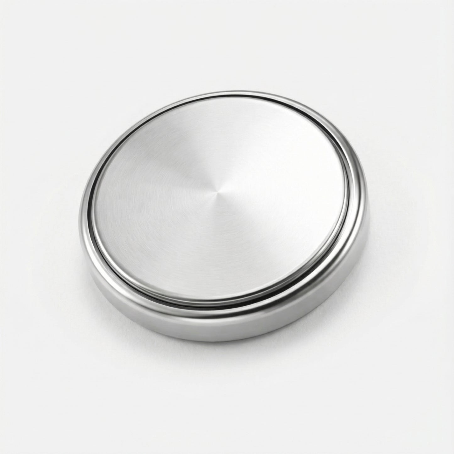 Silver metallic button on a white background