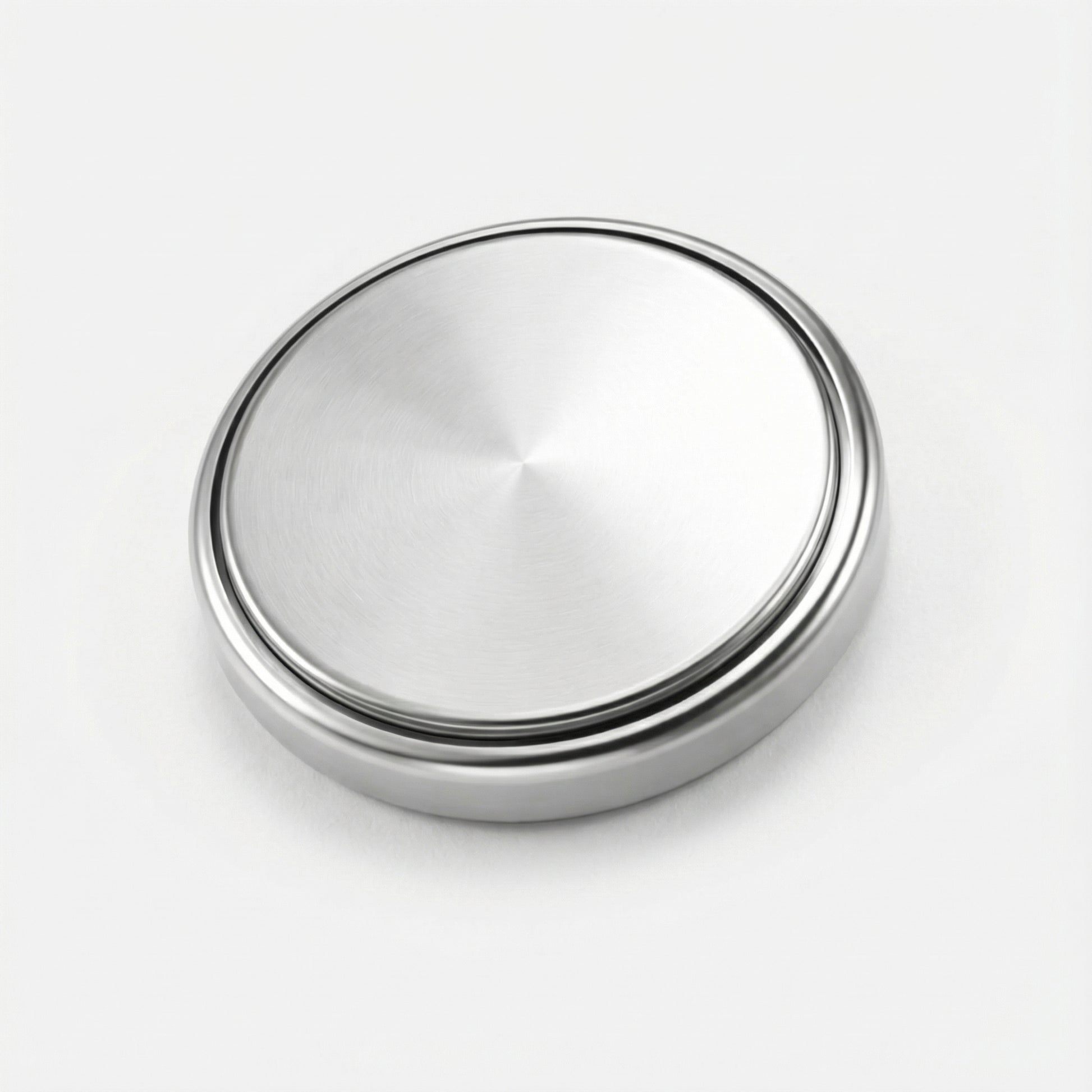 Silver metallic button on a white background