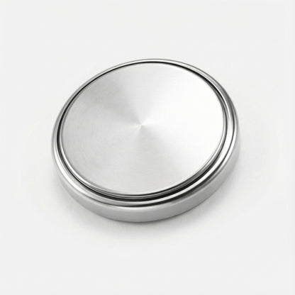 Silver metallic button on a white background