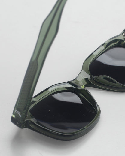Close-up of the black lens and olive green temple of the Billie Sunglasses Nova