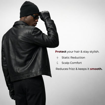Man wearing a black leather jacket and hat with text about hair care product benefits on a gray background