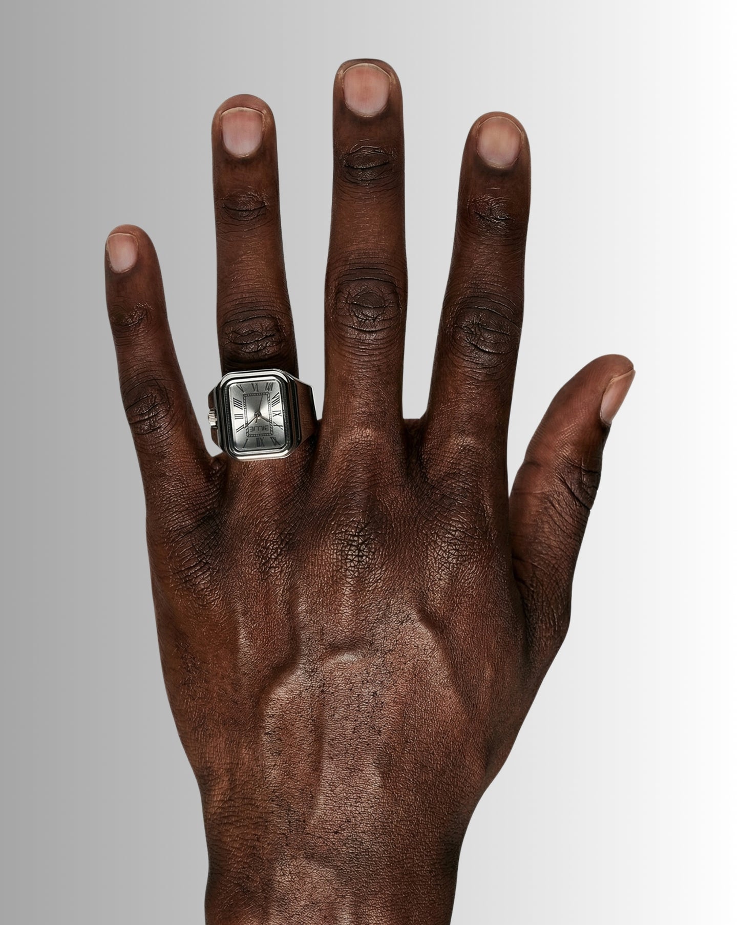 Close-up of a hand with a silver ring on the index finger.