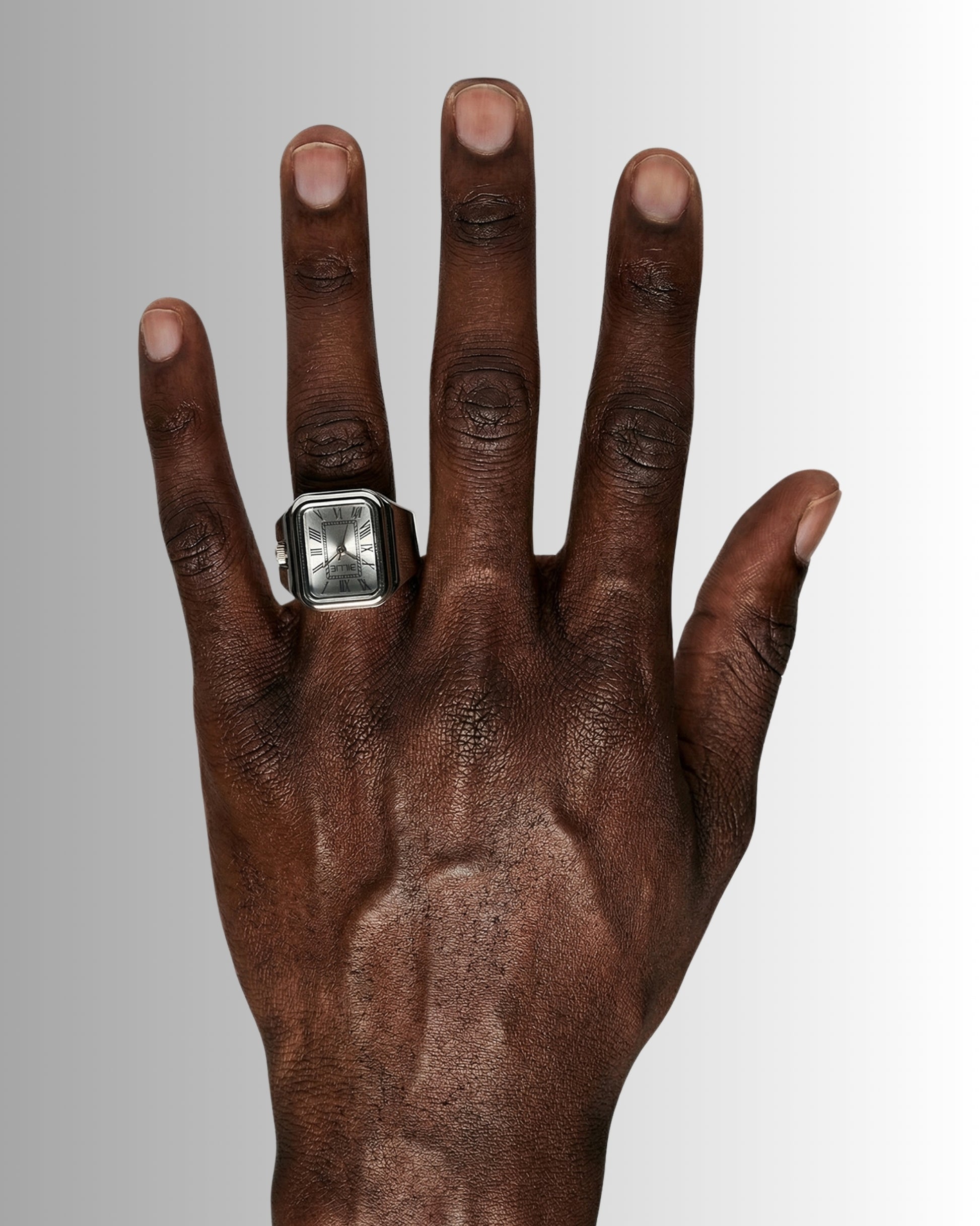 Close-up of a hand with a silver ring on the index finger.