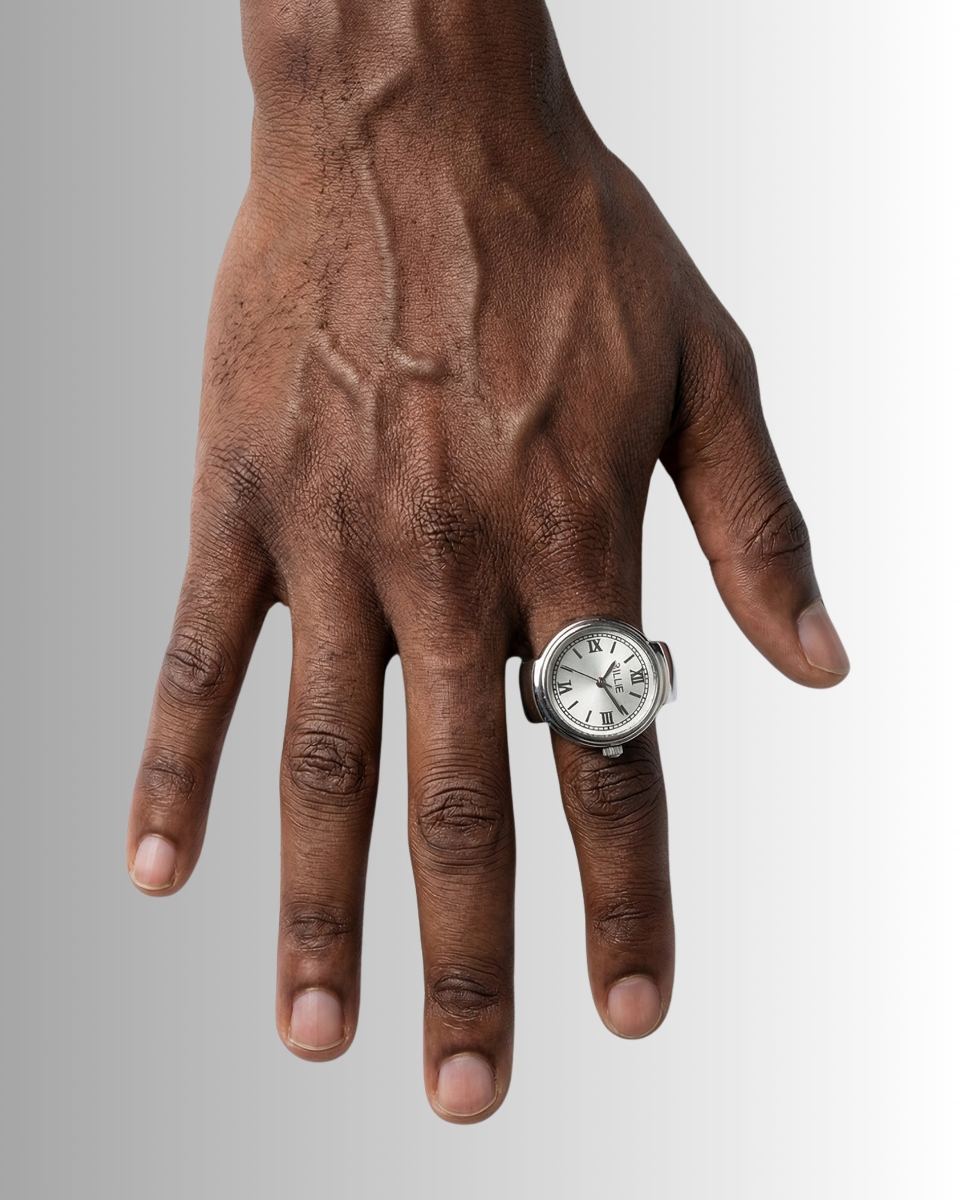 Close-up of a hand with a silver watch on the ring finger.