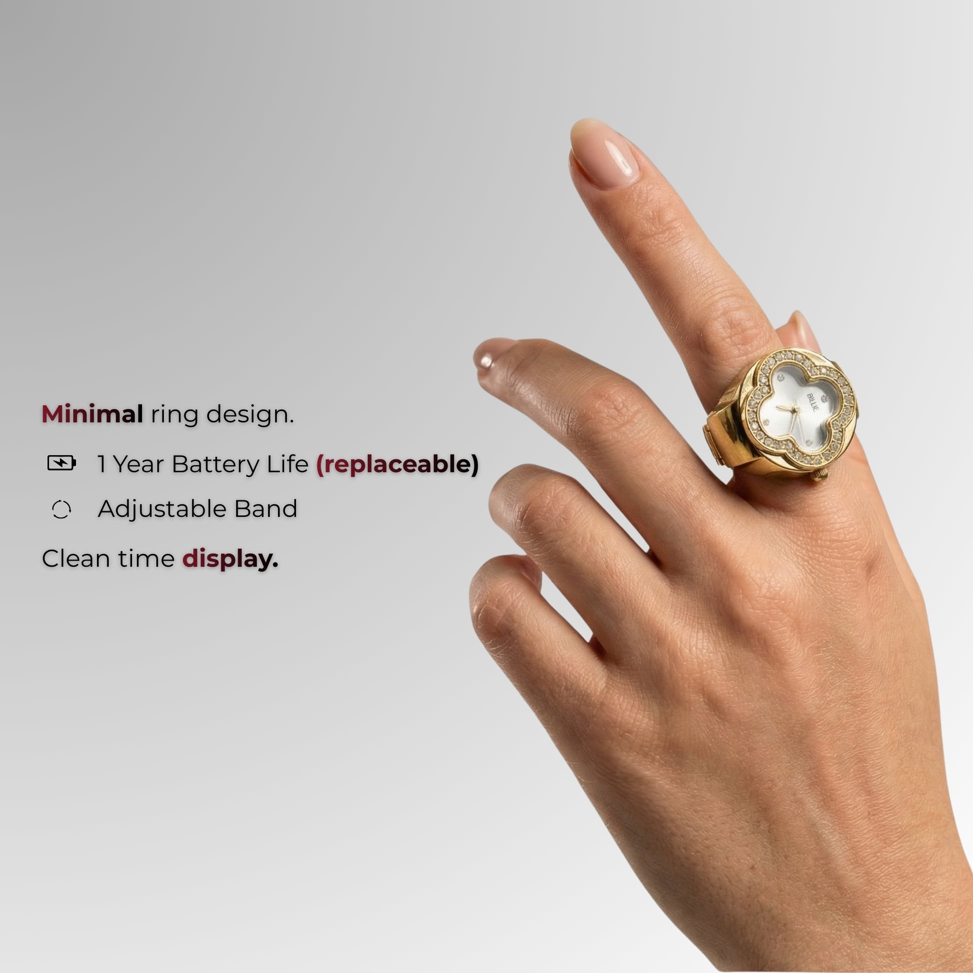 Gold ring with a stone on a finger against a gray background