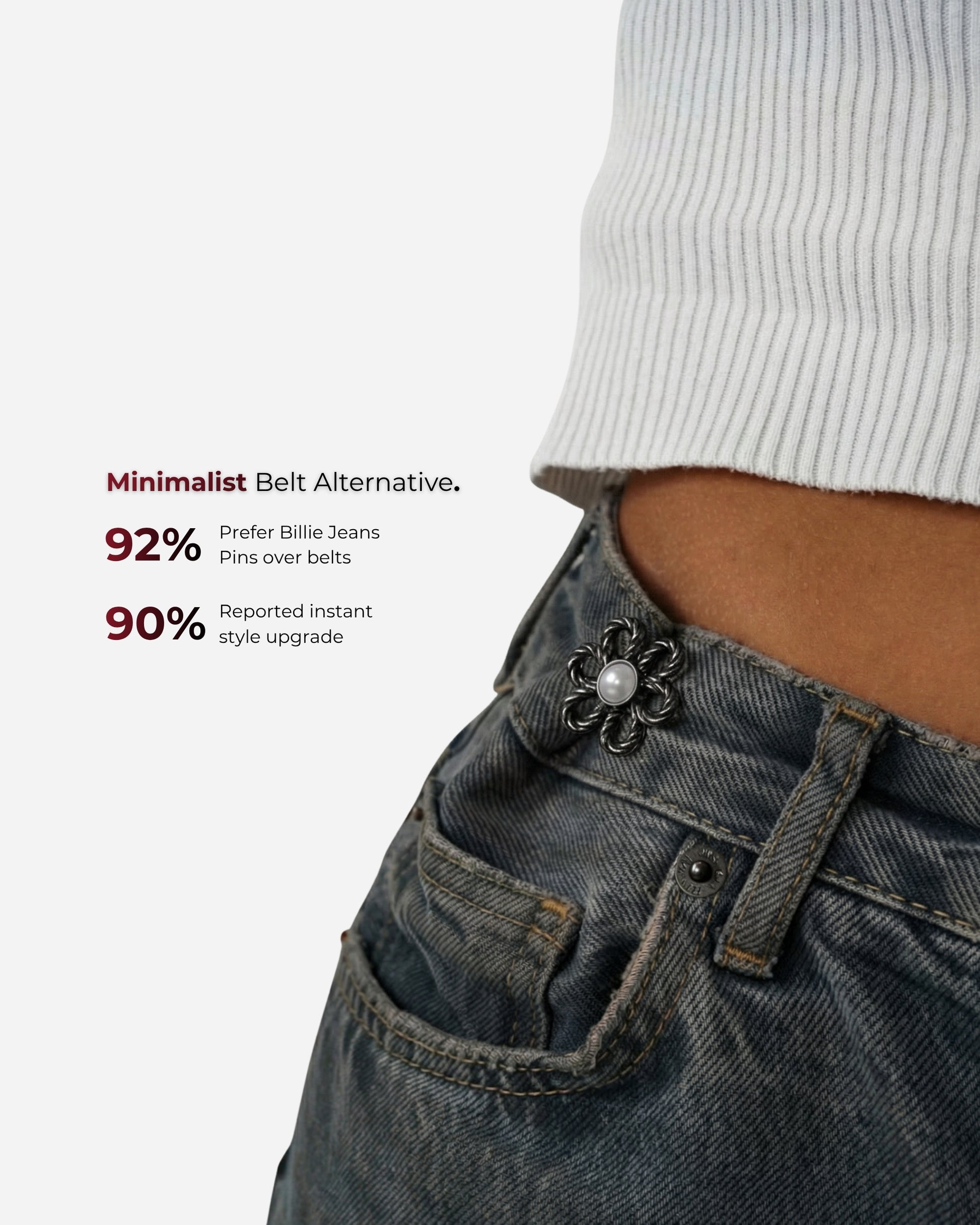 Close-up of a waist with a decorative pin on denim pants and a ribbed top.