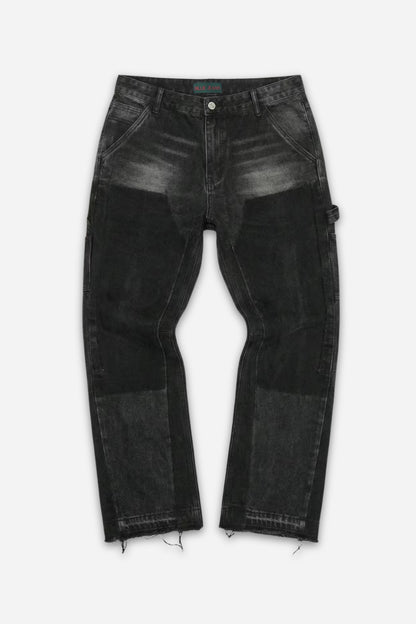 Black washed carpenter jeans with paneled construction and raw-cut hems by Billie Jeans