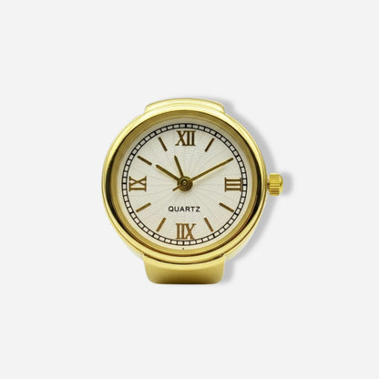 Gold ring watch with a white face and Roman numerals on a light gray background