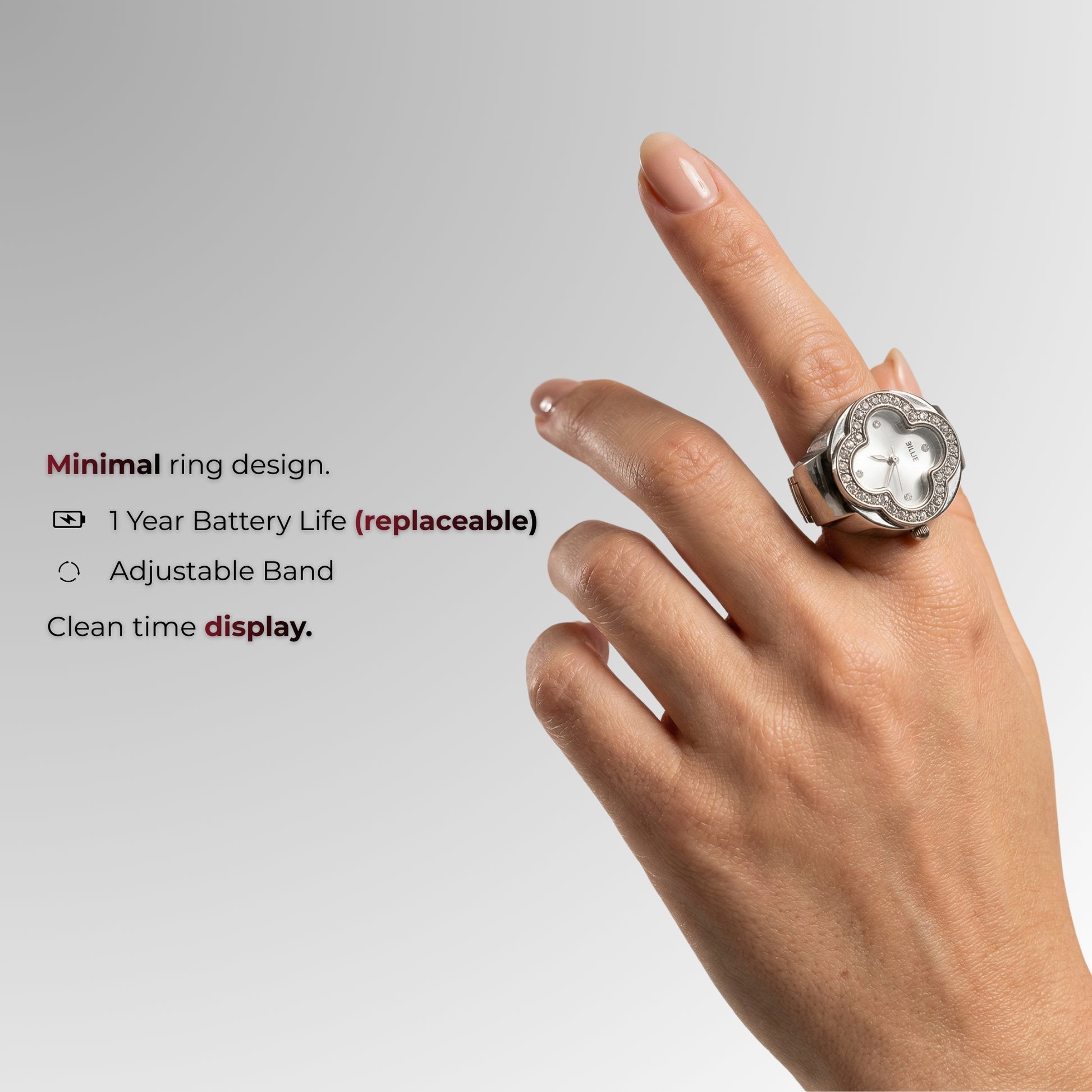 Ring mit Digitalanzeige an einem Finger vor grauem Hintergrund