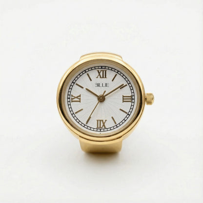 Gold watch with white face and Roman numerals on a light gray background