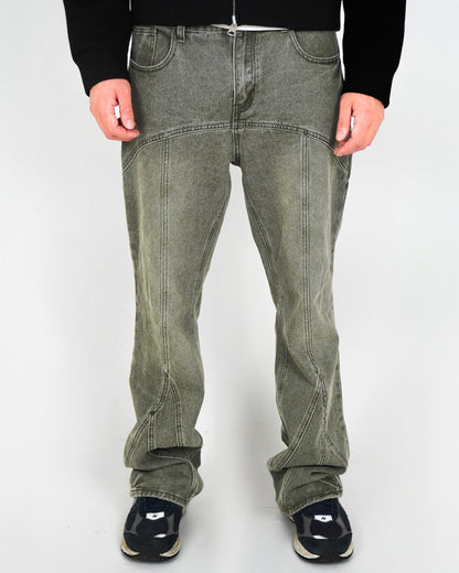 Person wearing green pants and black shoes, standing against a light background.