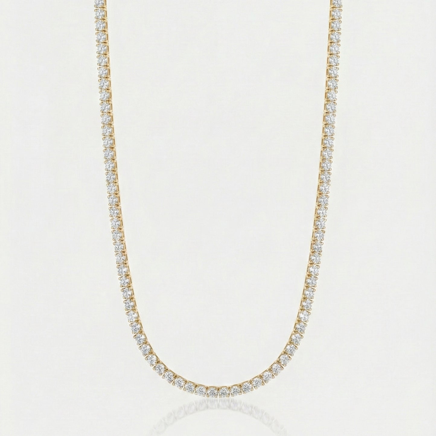 Gold tennis chain on white background