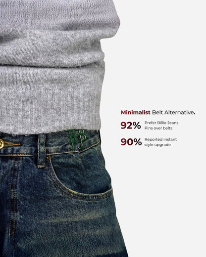 Close-up of a gray sweater and denim jeans with visible pins and text.