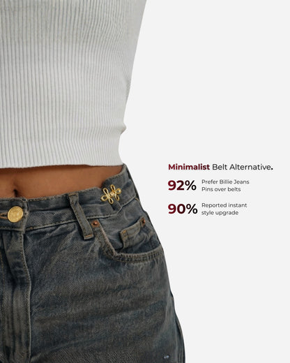 Close-up of a waist with a pin on jeans and a ribbed top.