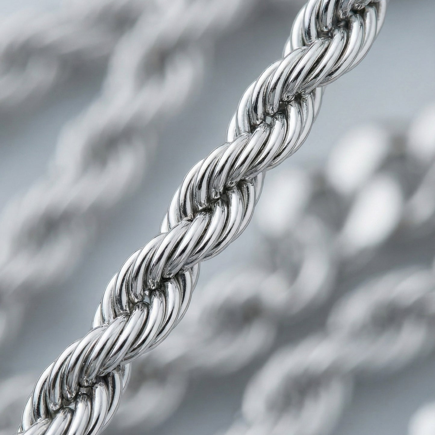 Close-up of a silver rope chain with a blurred background