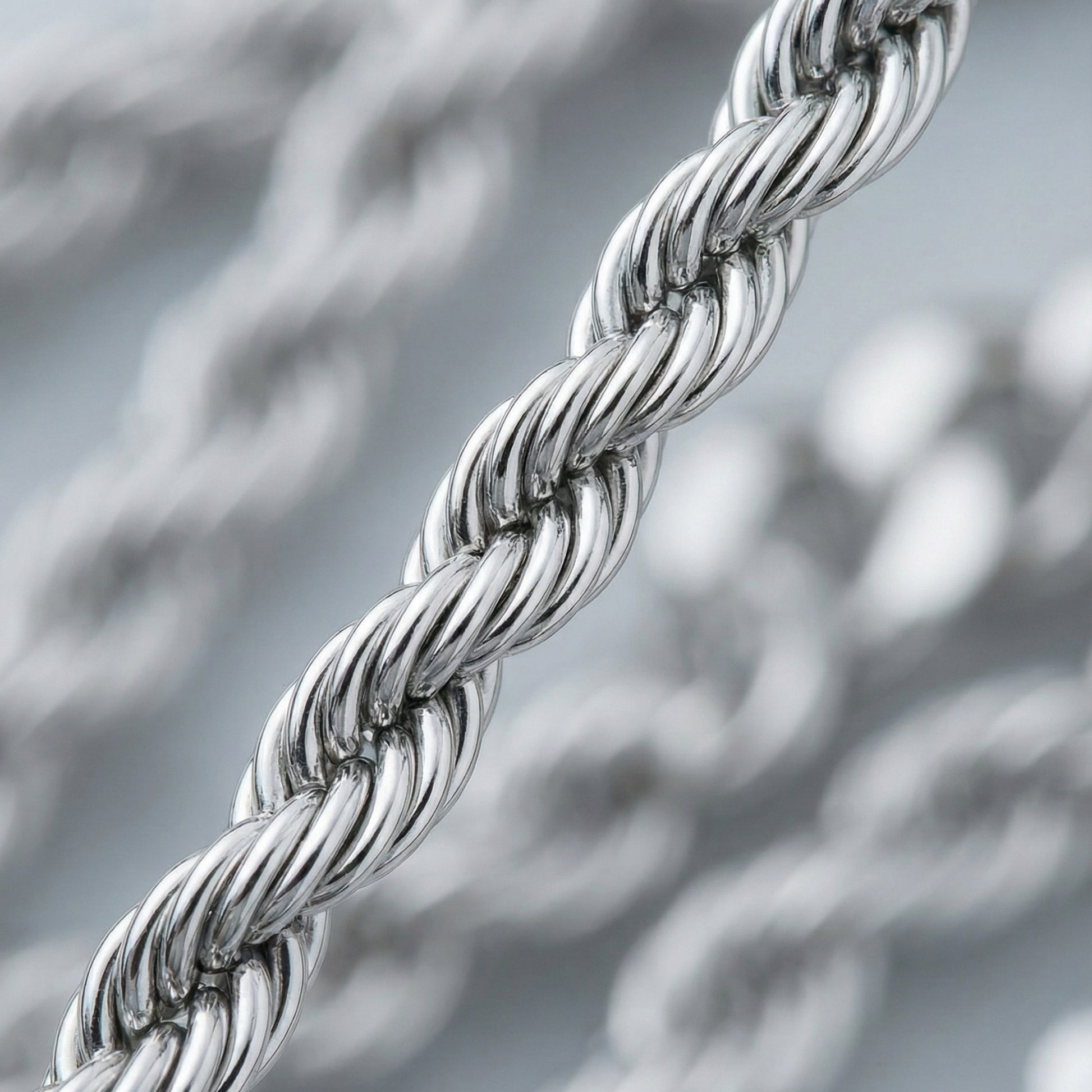 Close-up of a silver rope chain with a blurred background