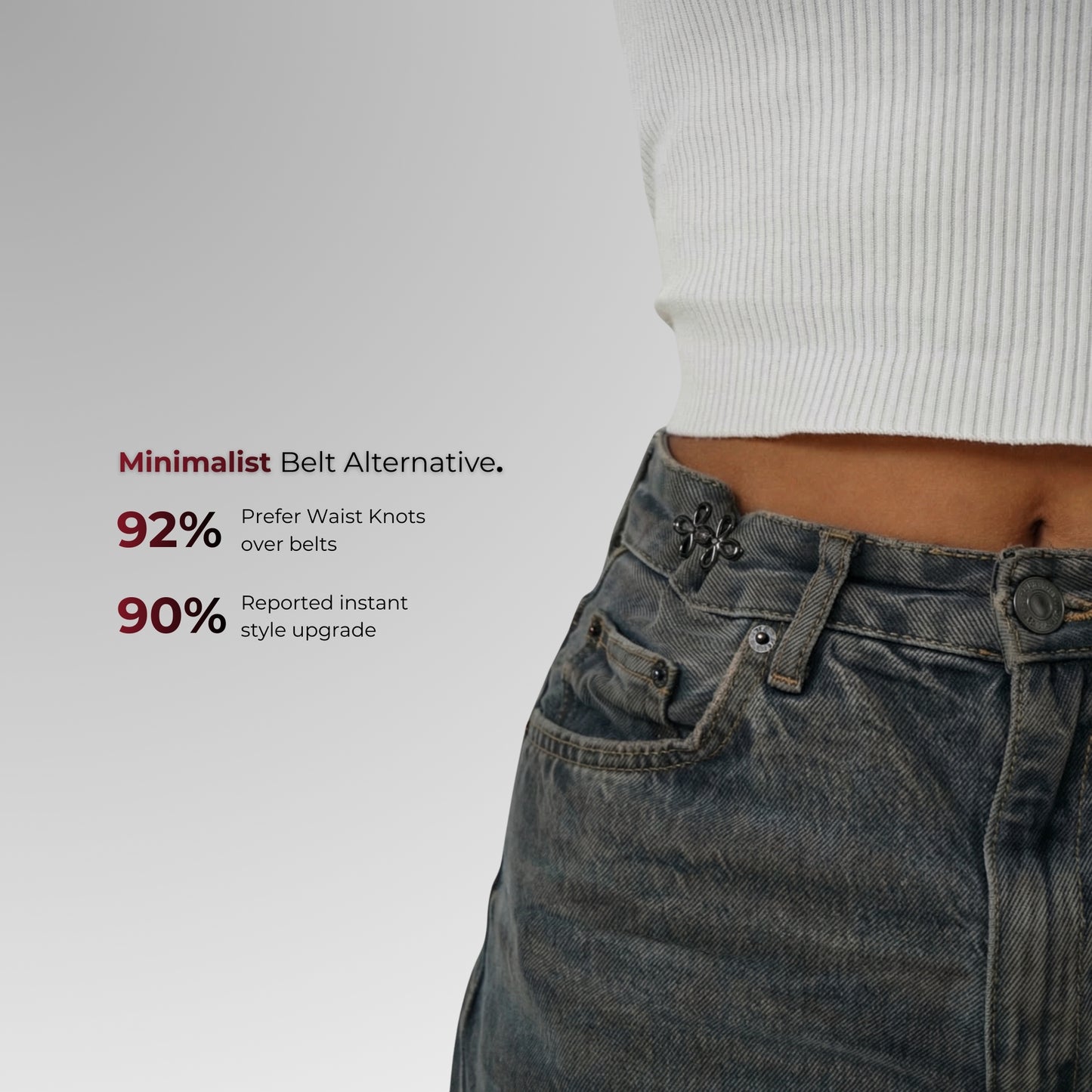 Person wearing jeans with waist knots on a plain background