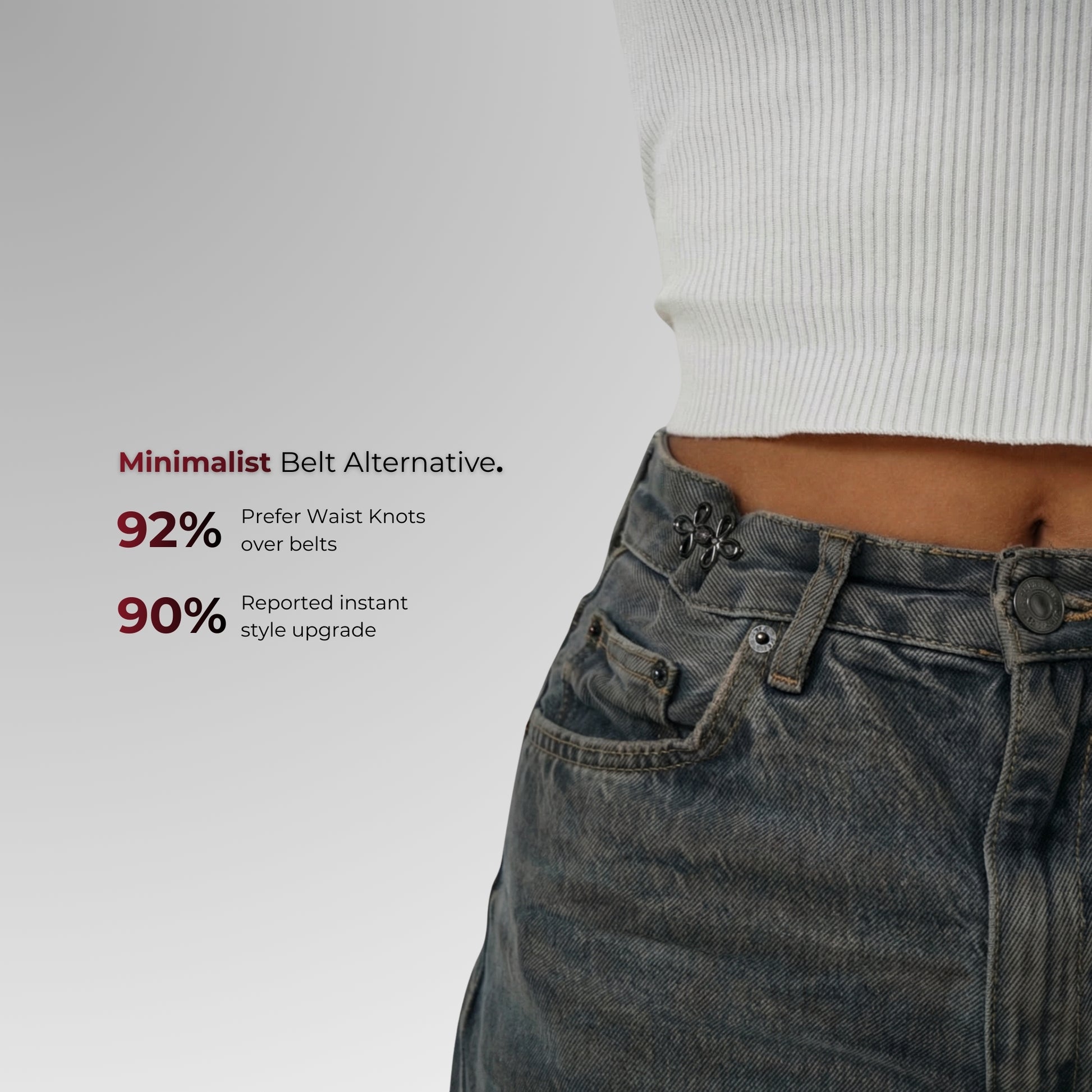 Person wearing jeans with waist knots on a plain background