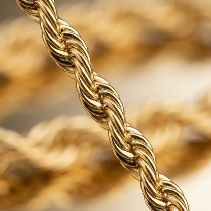 Close-up of a gold rope chain with a blurred background