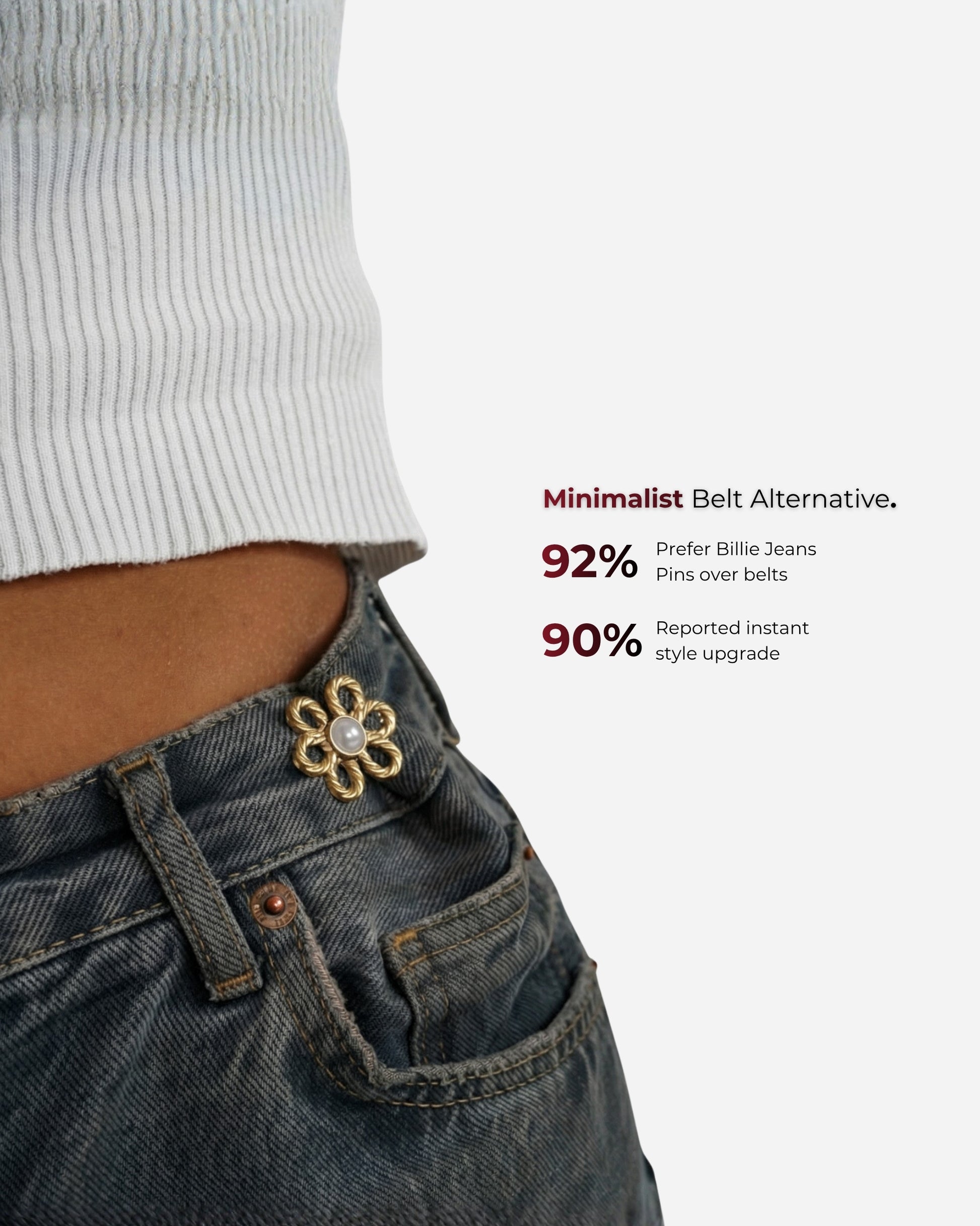 Close-up of a waist with a flower pin on denim jeans and a ribbed top.