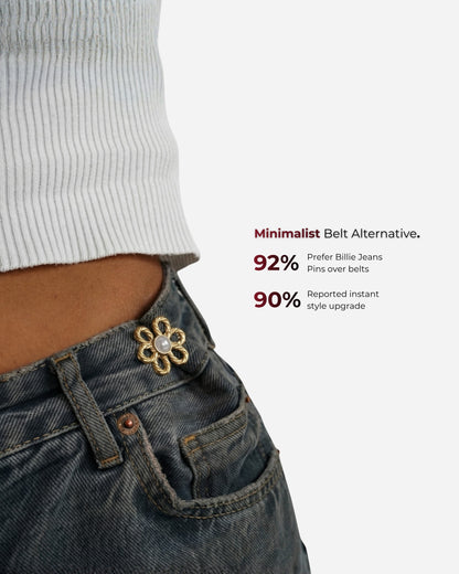Close-up of a waist with a flower pin on denim jeans and a ribbed top.