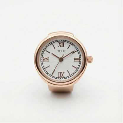 Rose gold watch with white face and Roman numerals on a light gray background