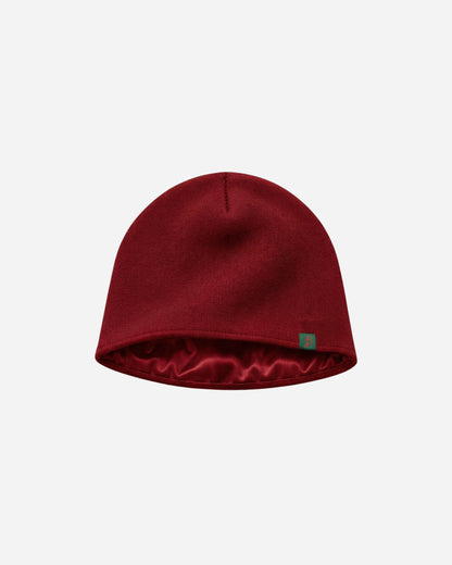 Red beanie hat on a plain white background