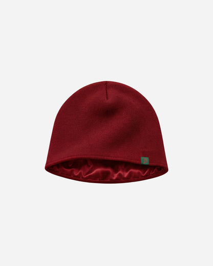 Billie Satin Beanie in burgundy with satin lining and green Billie label, on a light background
