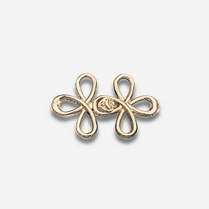 Gold sculpted waist knot on a light gray background