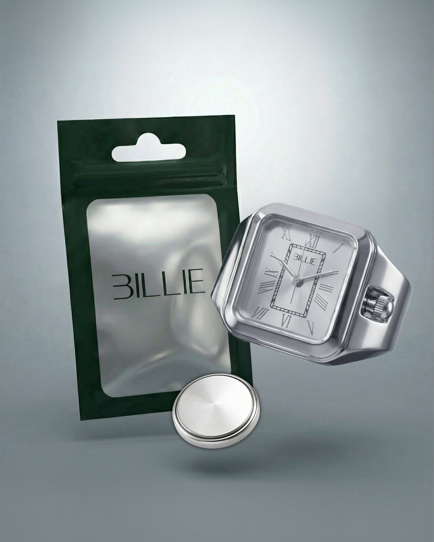 Silver watch with a white face and a green packaging behind it.