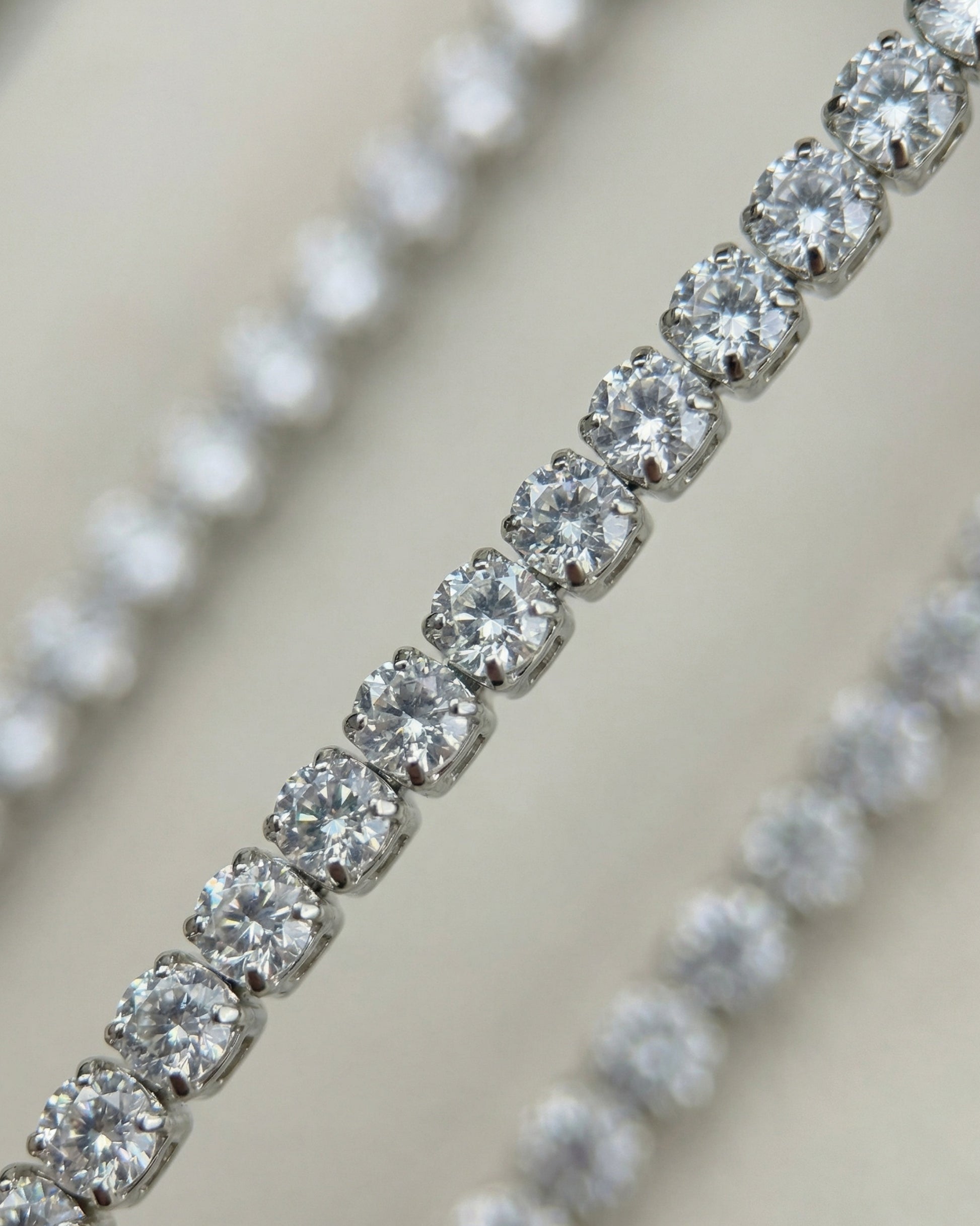 Close-up of multiple rows of sparkling clear gemstones set in metal.