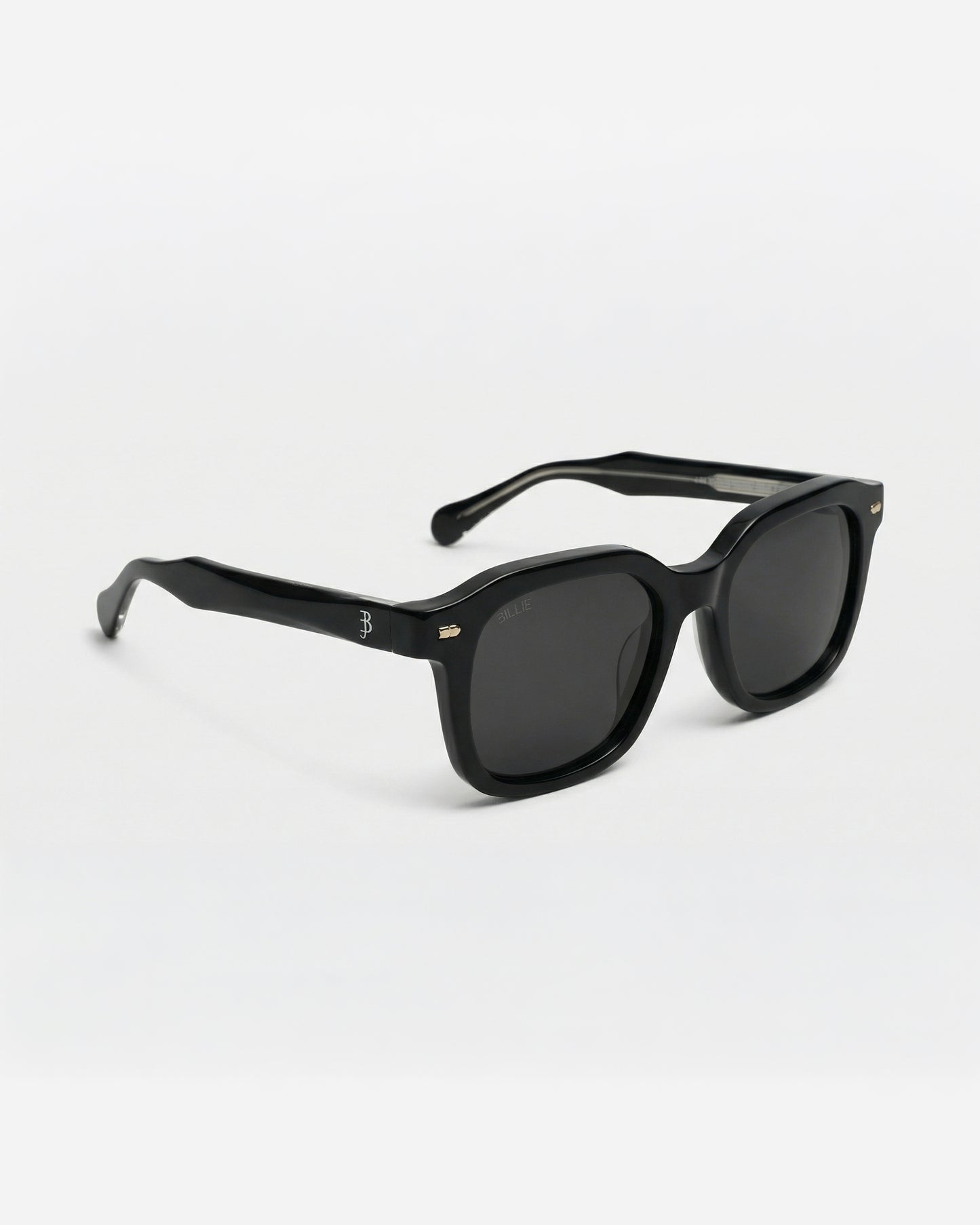 Black sunglasses with a thick frame on a plain background